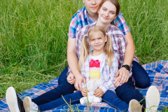 Happy family enjoying picnic in nature