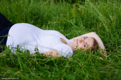 Beautiful pregnant woman relaxing on grass