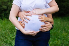 Closeup pictures of pregnant woman's belly with hands