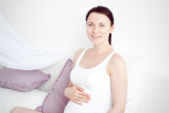 young pregnant woman in the bedroom