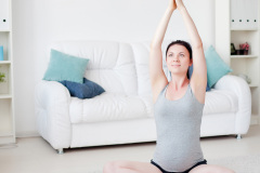 Young pregnant woman do yoga indoors