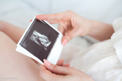 Young pregnant woman in the bedroom