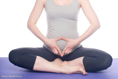 Beautiful pregnant woman practicing yoga