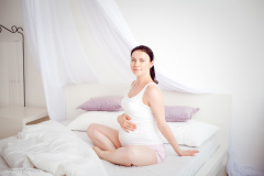 young pregnant woman in the bedroom